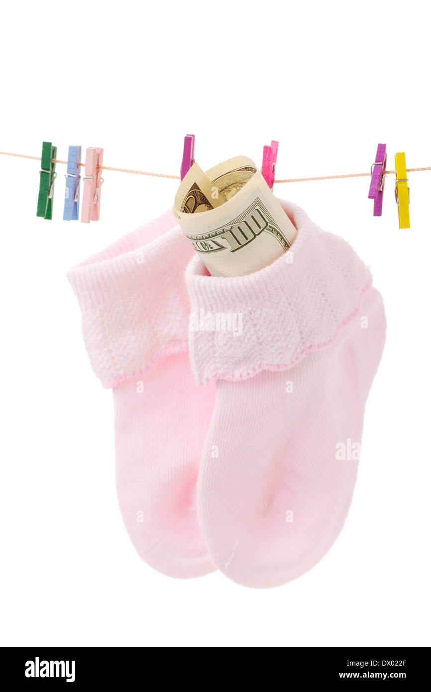 Money in sock on laundry line with pink clothespins, isolated on white Stock Photo
