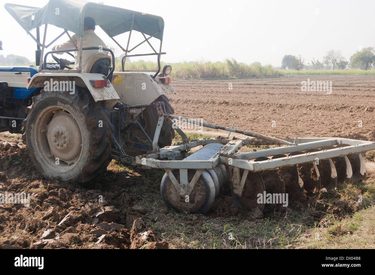 1Indian Farmer Driving Tractor in Plowed Field Stock Photo - Alamy