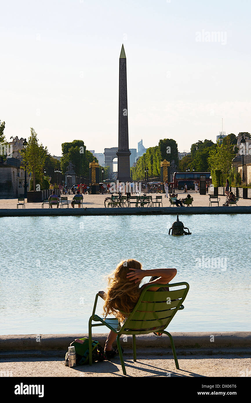 Woman sitting on chair at Tuileries garden in Paris, France Stock Photo