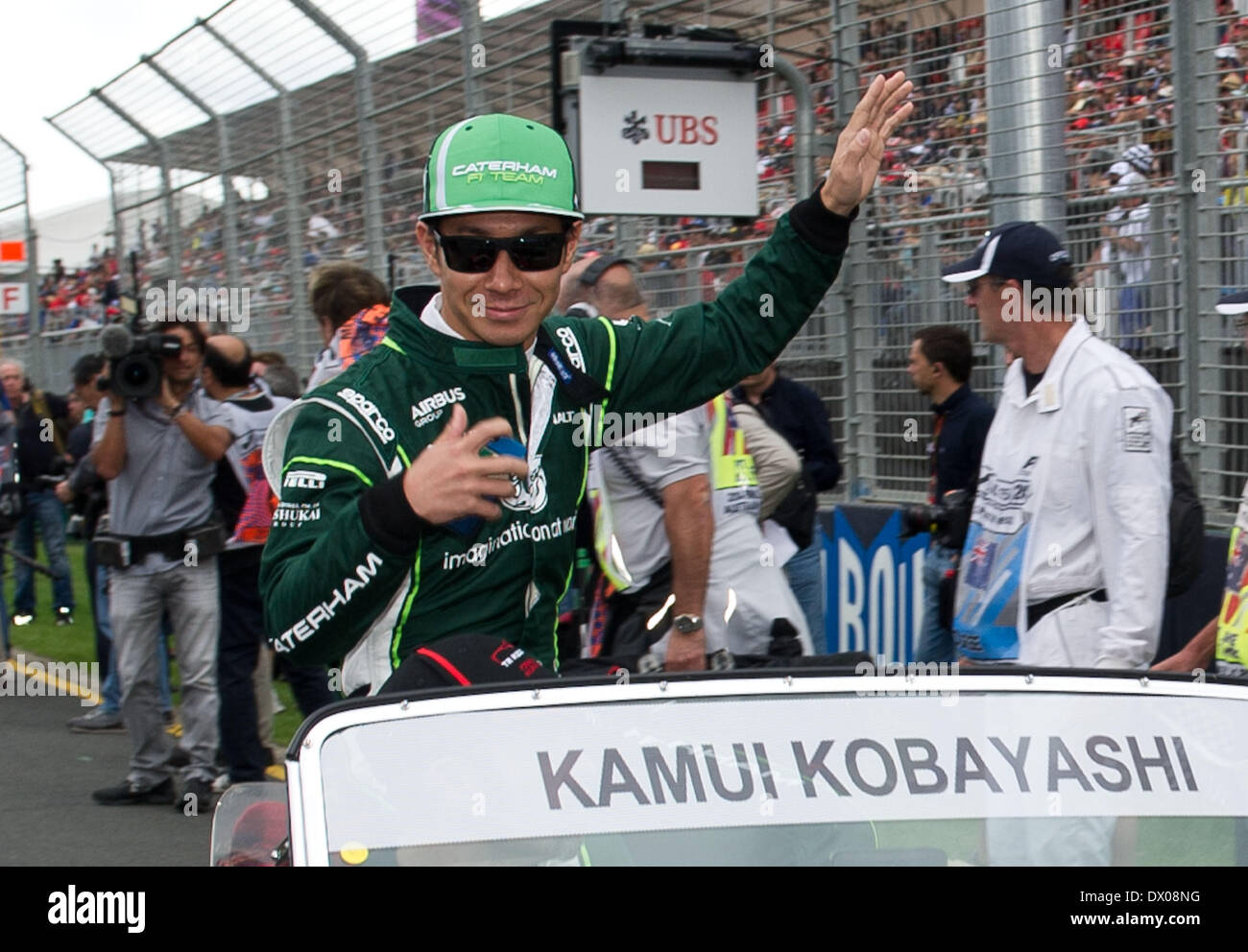 Melbourne, Australia. 16th Mar, 2014. Caterham Formula one driver Kamui Kobayashi of Japan takes selfies during the driver's parade before the Australian Formula One Grand Prix at the Albert Park circuit in Melbourne, Australia, March 16, 2014. Credit:  Bai Xue/Xinhua/Alamy Live News Stock Photo