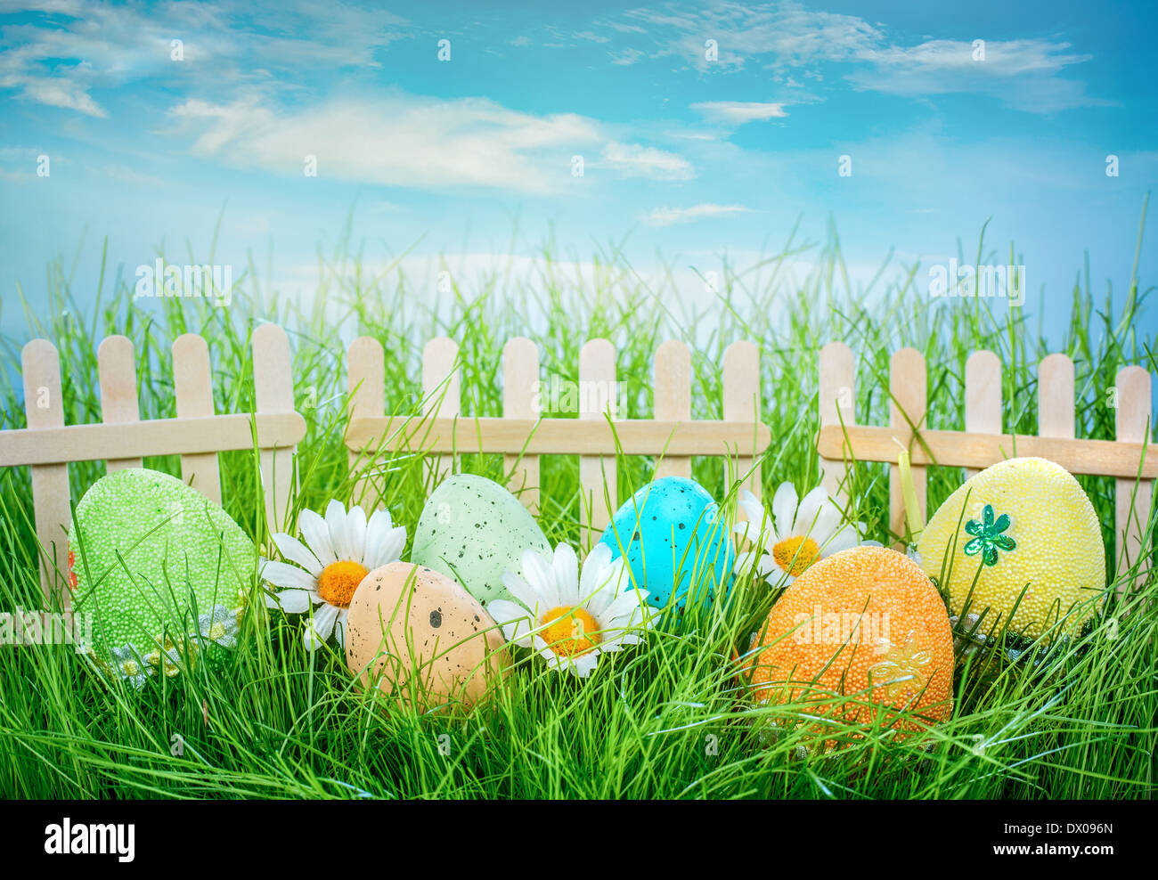Decorated easter eggs in the grass on blue sky background Stock Photo ...