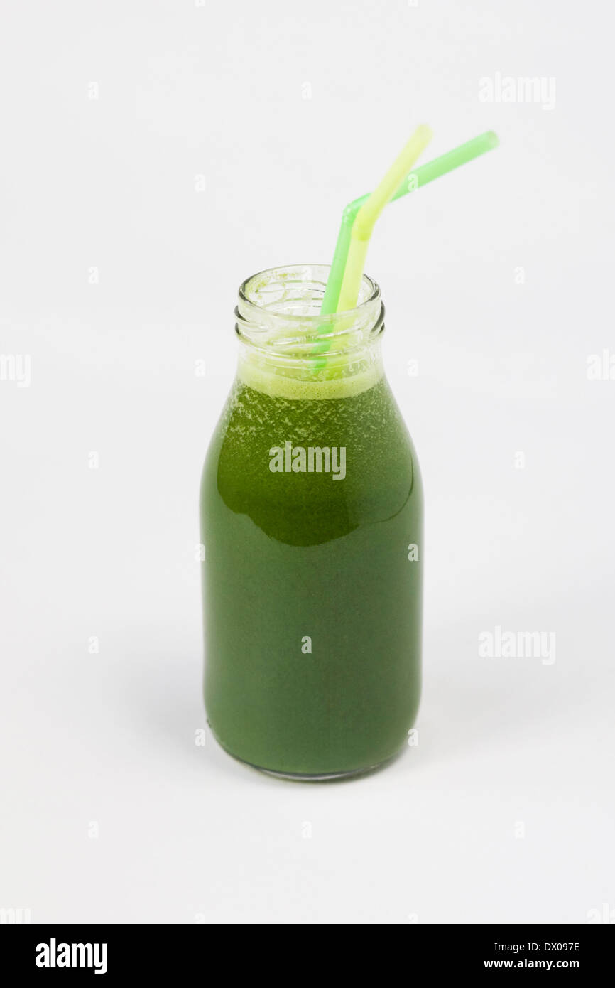 Fresh spinach, apple, celery, ginger and lime juice in a glass bottle. Stock Photo
