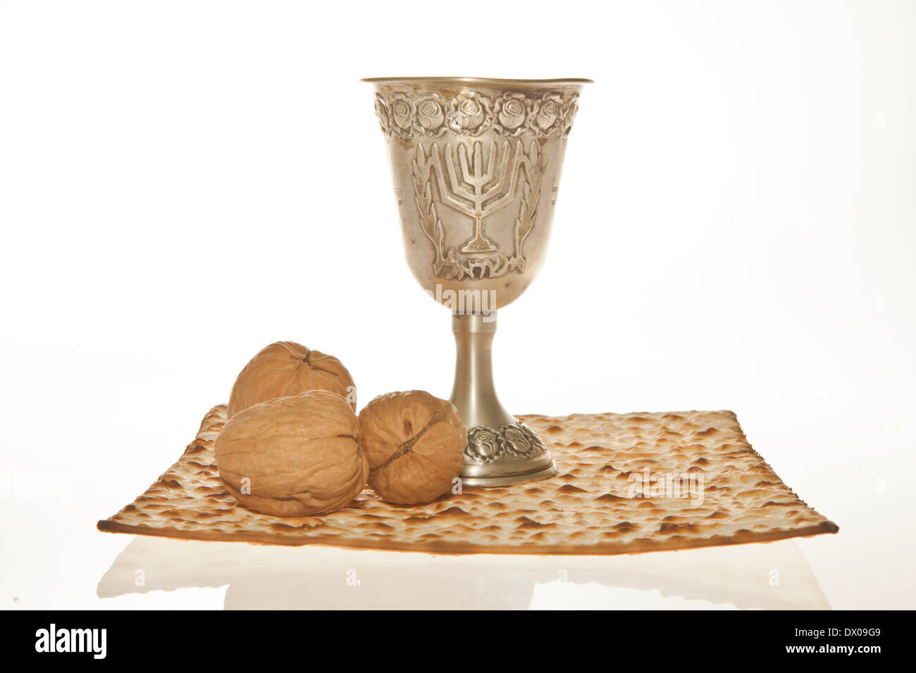 Matzoth, silver Kiddush cup and walnuts for Passover seder Stock Photo