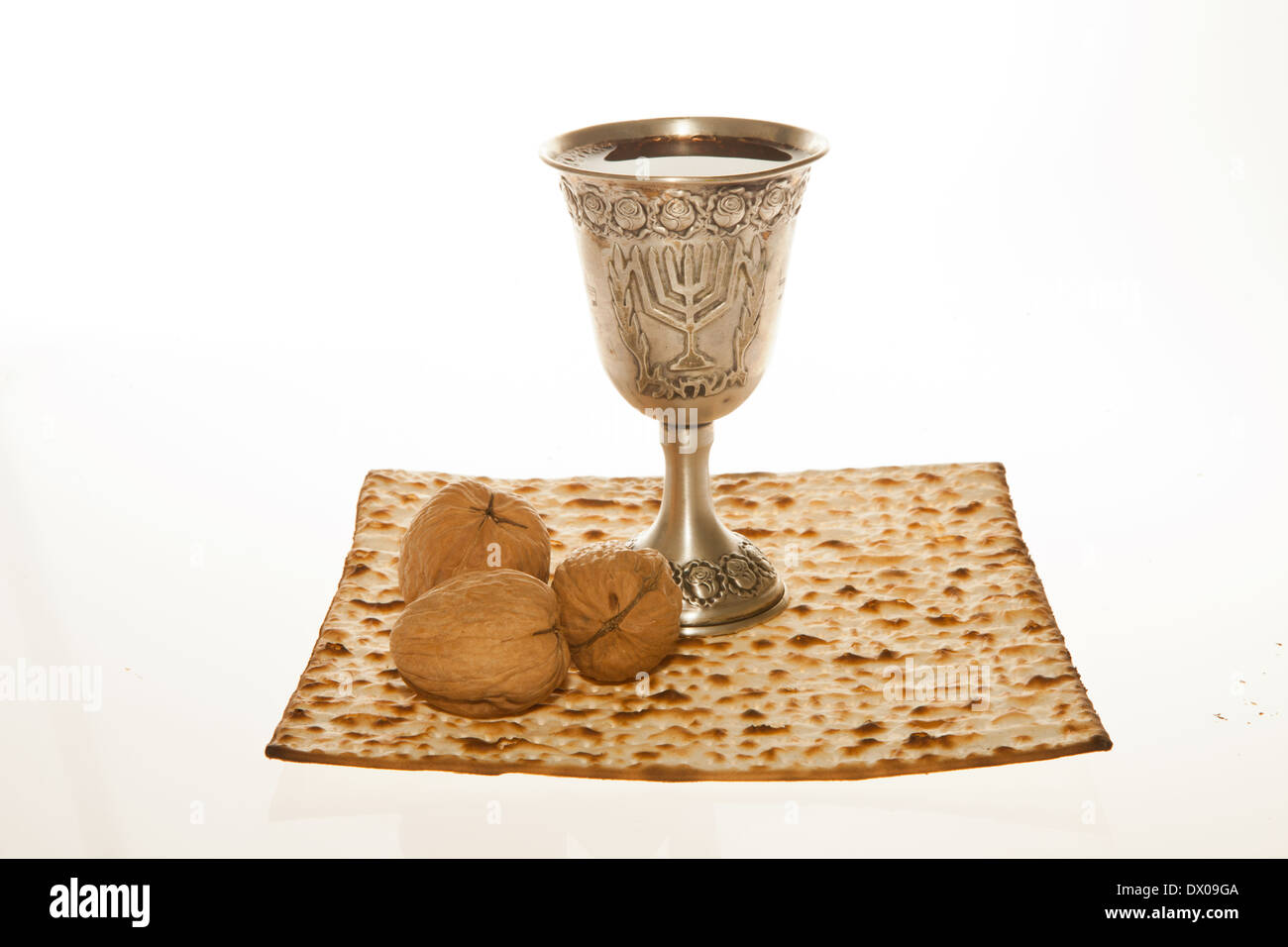 Matzoth, silver Kiddush cup and walnuts for Passover seder Stock Photo