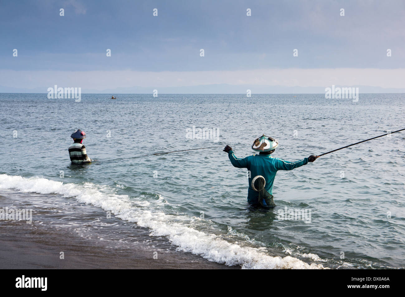 Local fisherman standing in the sea, holding a fishing rod to catch fish,  Lombok Island, Lesser Sunda Islands, Indonesia, Asia Stock Photo - Alamy