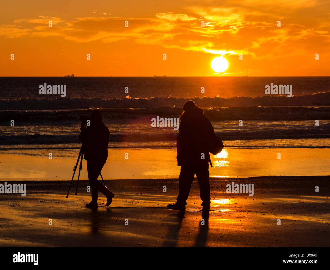 Sunday, 16th, March, 2014, Seaton Carew beach near Hartlepool north east England. Photographer at sunrise on Seaton Carew beach on the north east coast of England. Temperature in the mid to high teens are forecast for parts of the UK on Sunday. Stock Photo