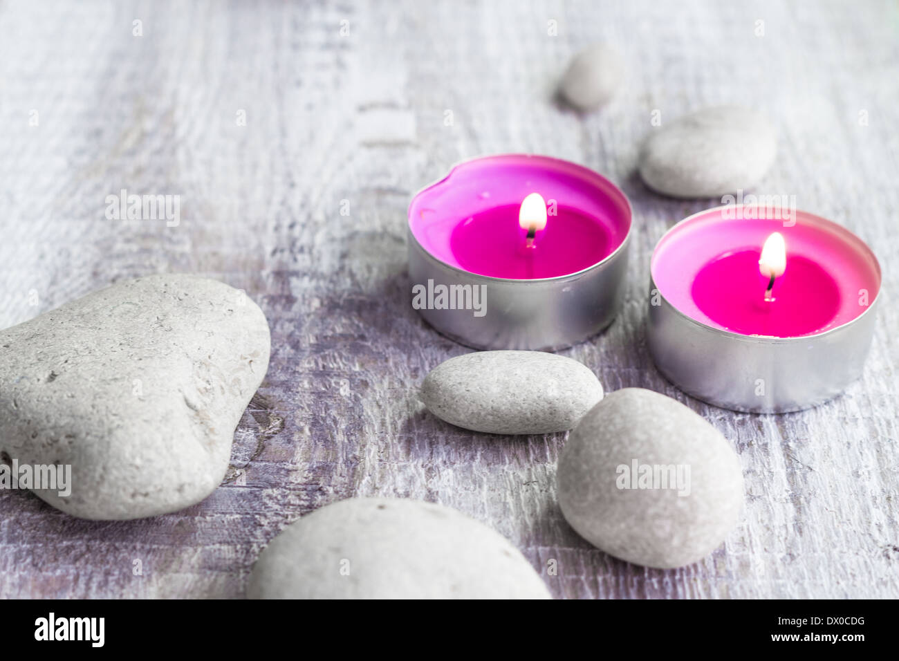 Spa concept with stones and aromatic candles Stock Photo
