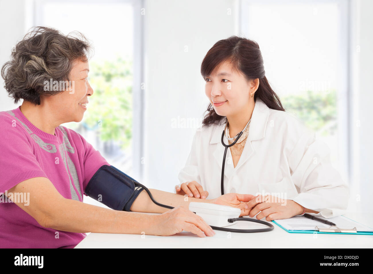 doctor measuring blood pressure of senior woman at home Stock Photo - Alamy