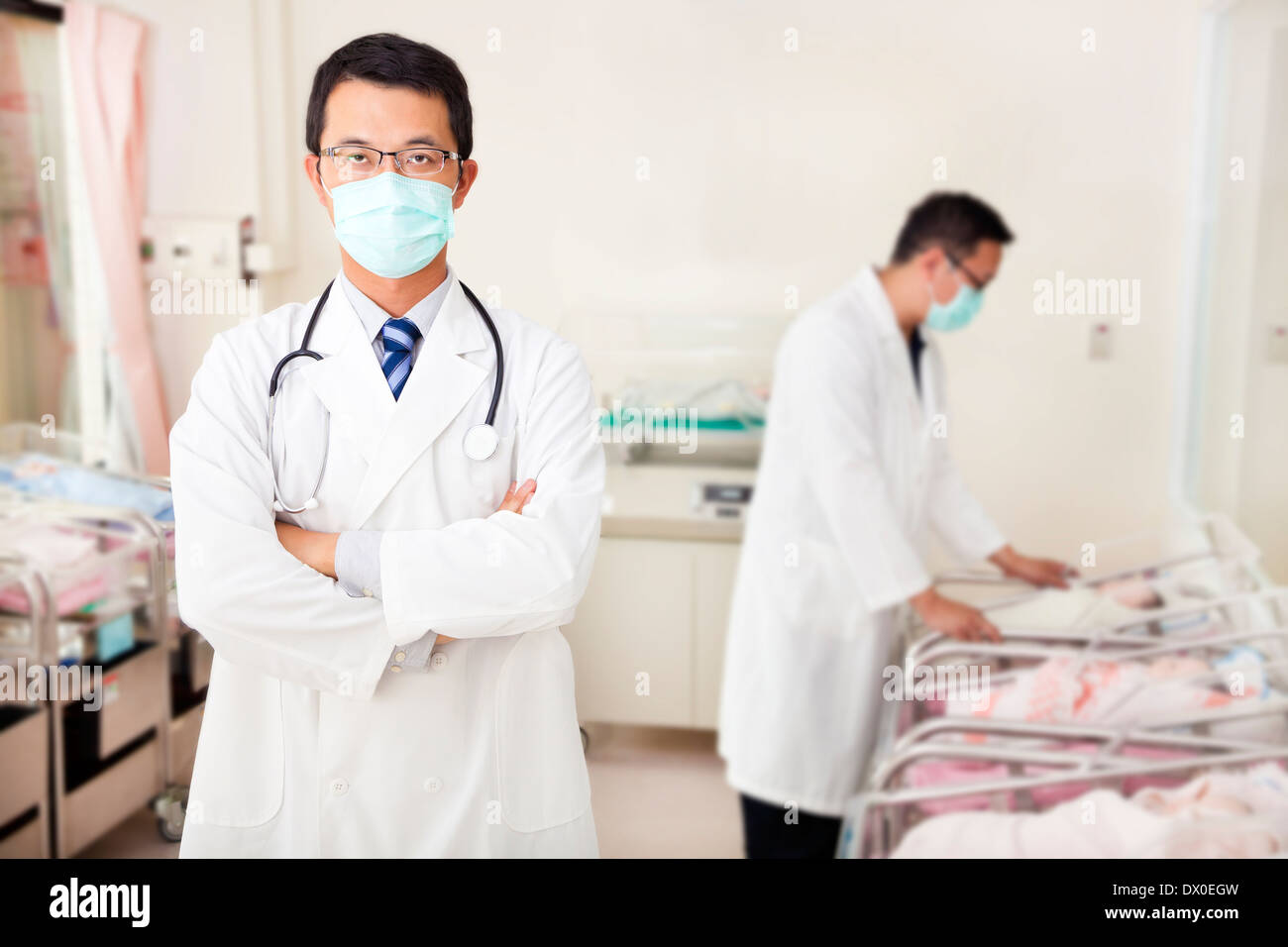 doctor and assistant care fake newborn baby  in baby room at hospital Stock Photo