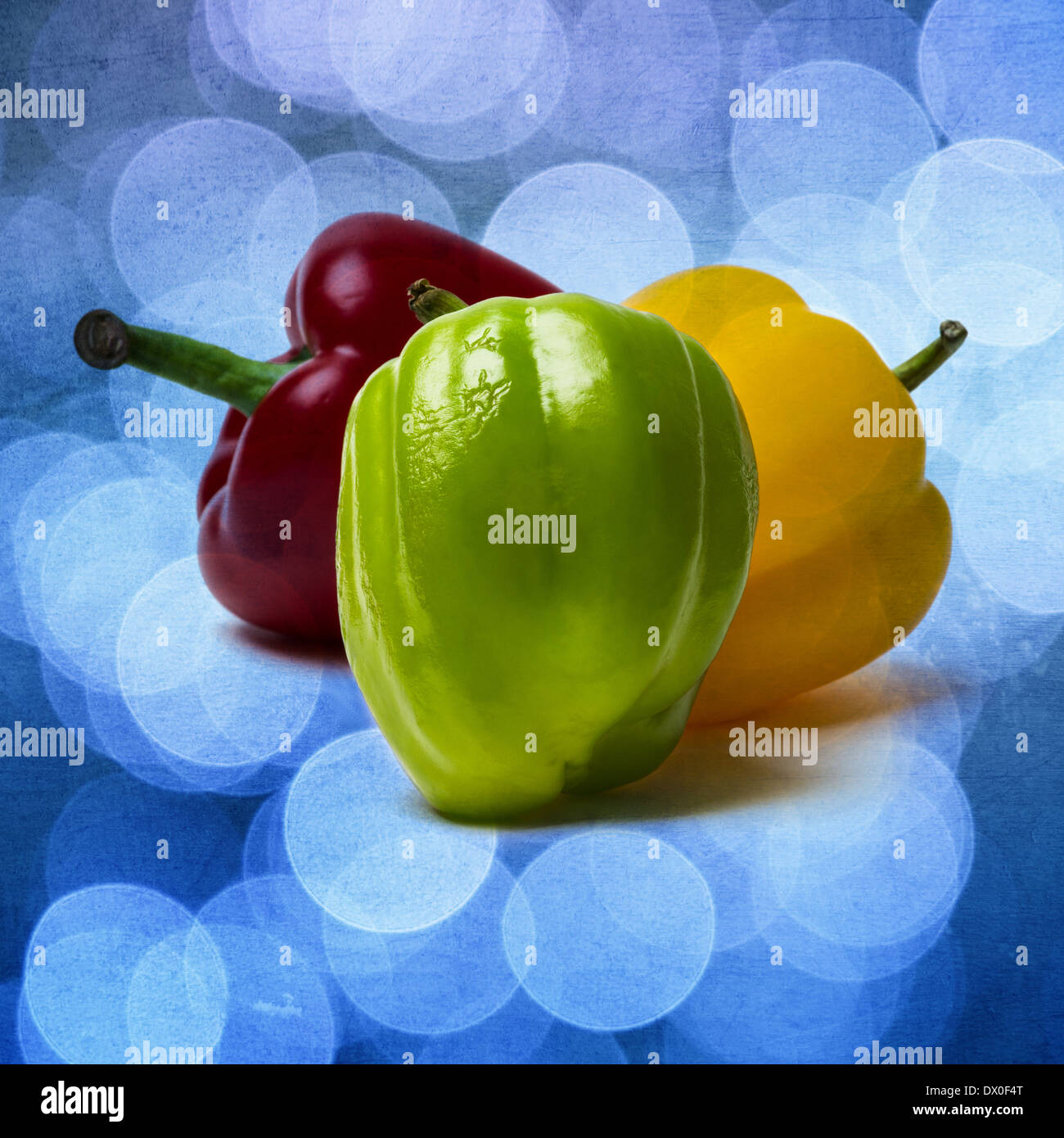 Three sweet peppers of red, yellow and green color. Green pepper is a