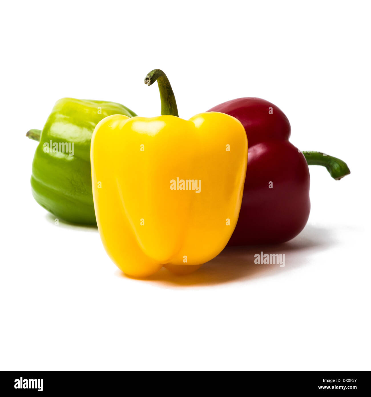 Three sweet peppers of red, yellow and green color. Yellow pepper is a