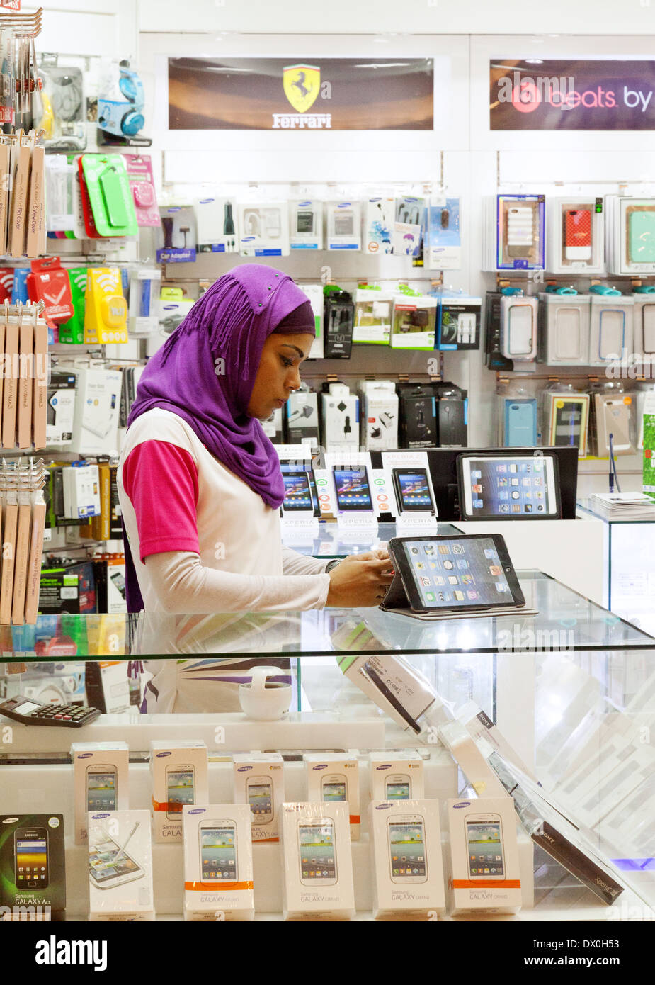 Muslim woman shop assistant at work in a technology store, Dubai Mall, Dubai, UAE, United Arab Emirates Middle East Stock Photo