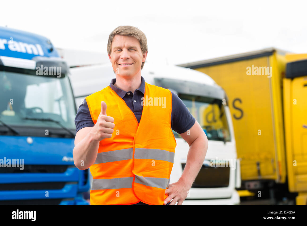 Logistics - proud driver or forwarder in front of trucks and trailers ...