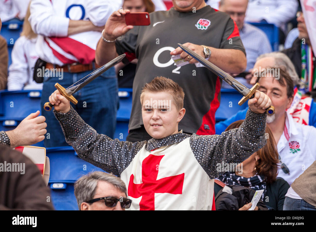 Young England rugby fan with a knight templar outfit brandishing two swords. Italy v England. RBS 6 Nations rugby. , Rome, Italy, 3/15/14. England beat Italy by 52 points to 11 at the Stadio Olimpico. Stock Photo