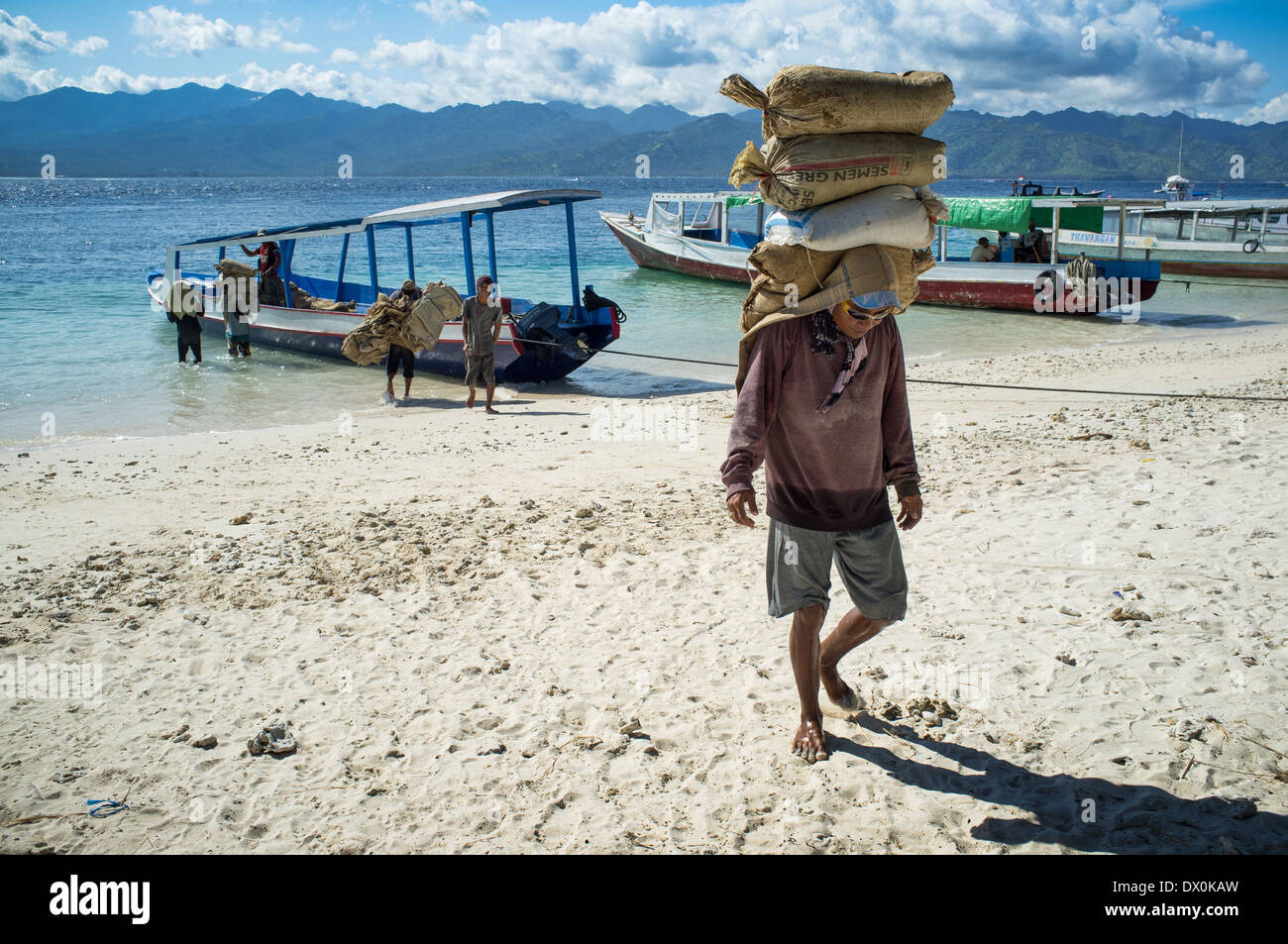 Cement carriers on Trawangan island.Indonesia. On small Indonesian islands (gili) there are no port, everything comes at beach Stock Photo