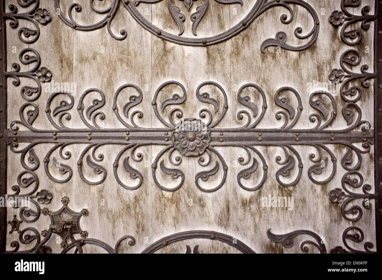 Toned image of a gothic pattern on a wooden doorway as a background. Stock Photo