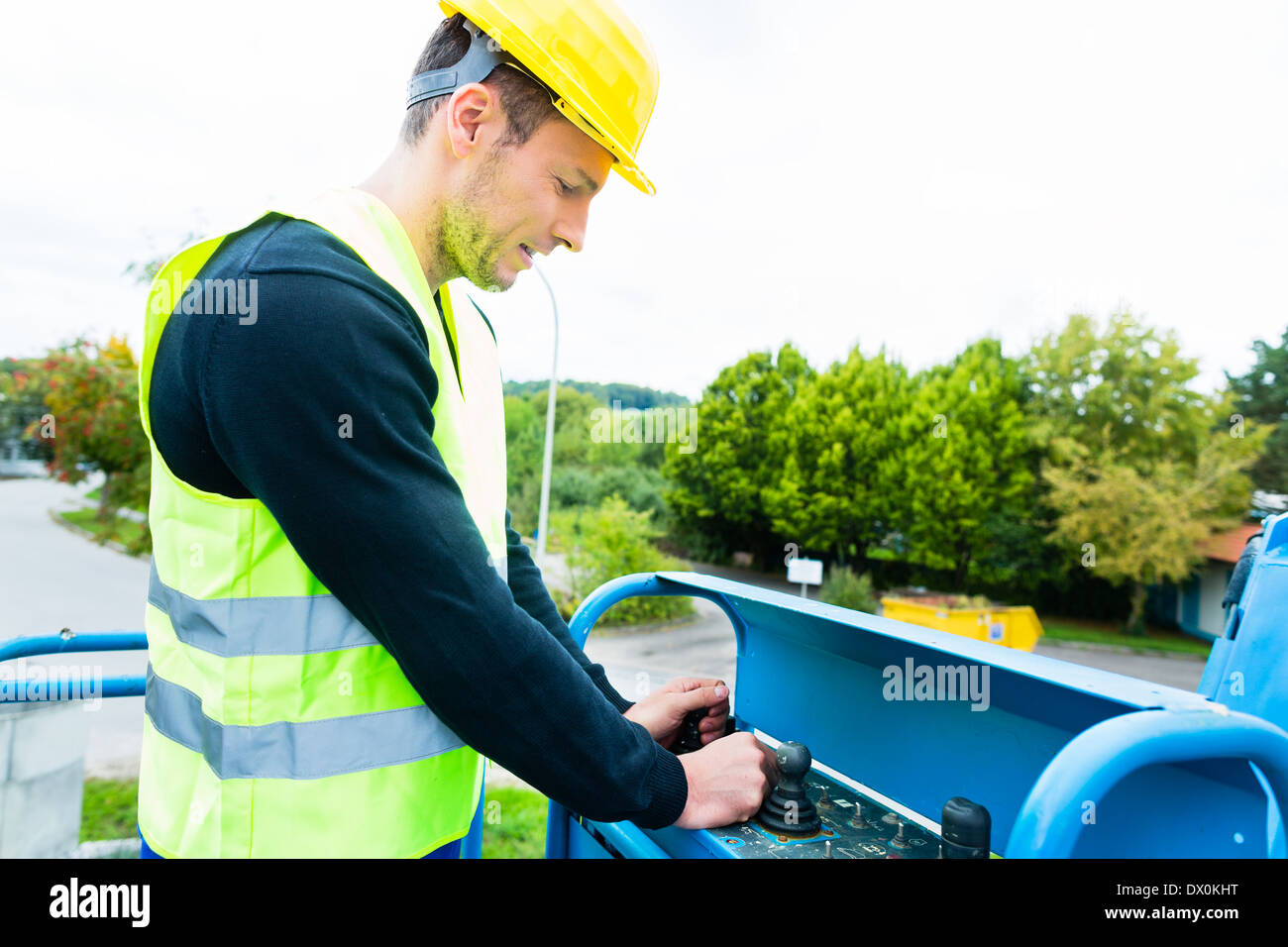 Construction workers or crane driver on site driving hydraulic Stock