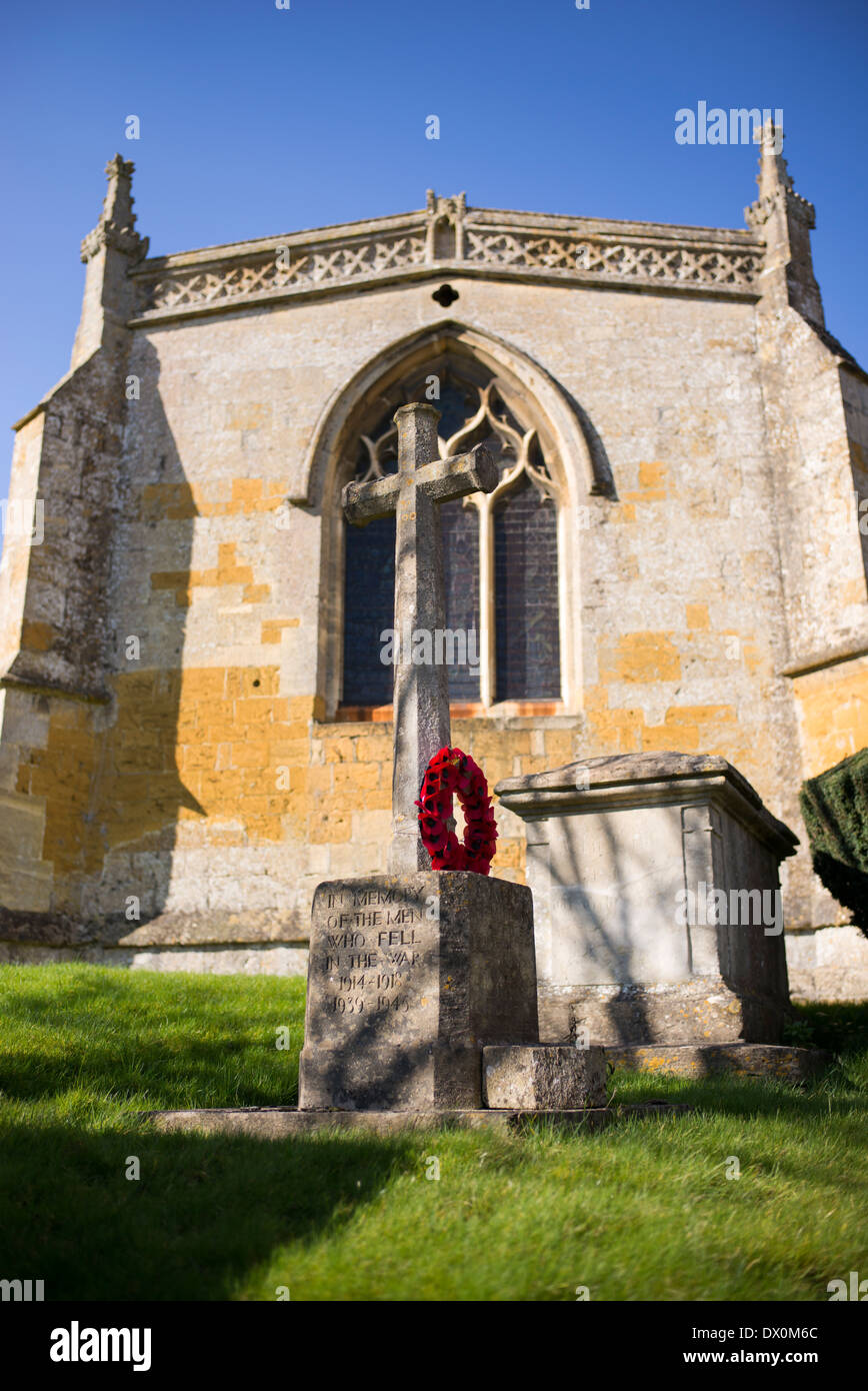 World War memorial and poppy wreath at St Lawrence Church, Bourton on the hill, Cotswolds, Gloucestershire, England Stock Photo