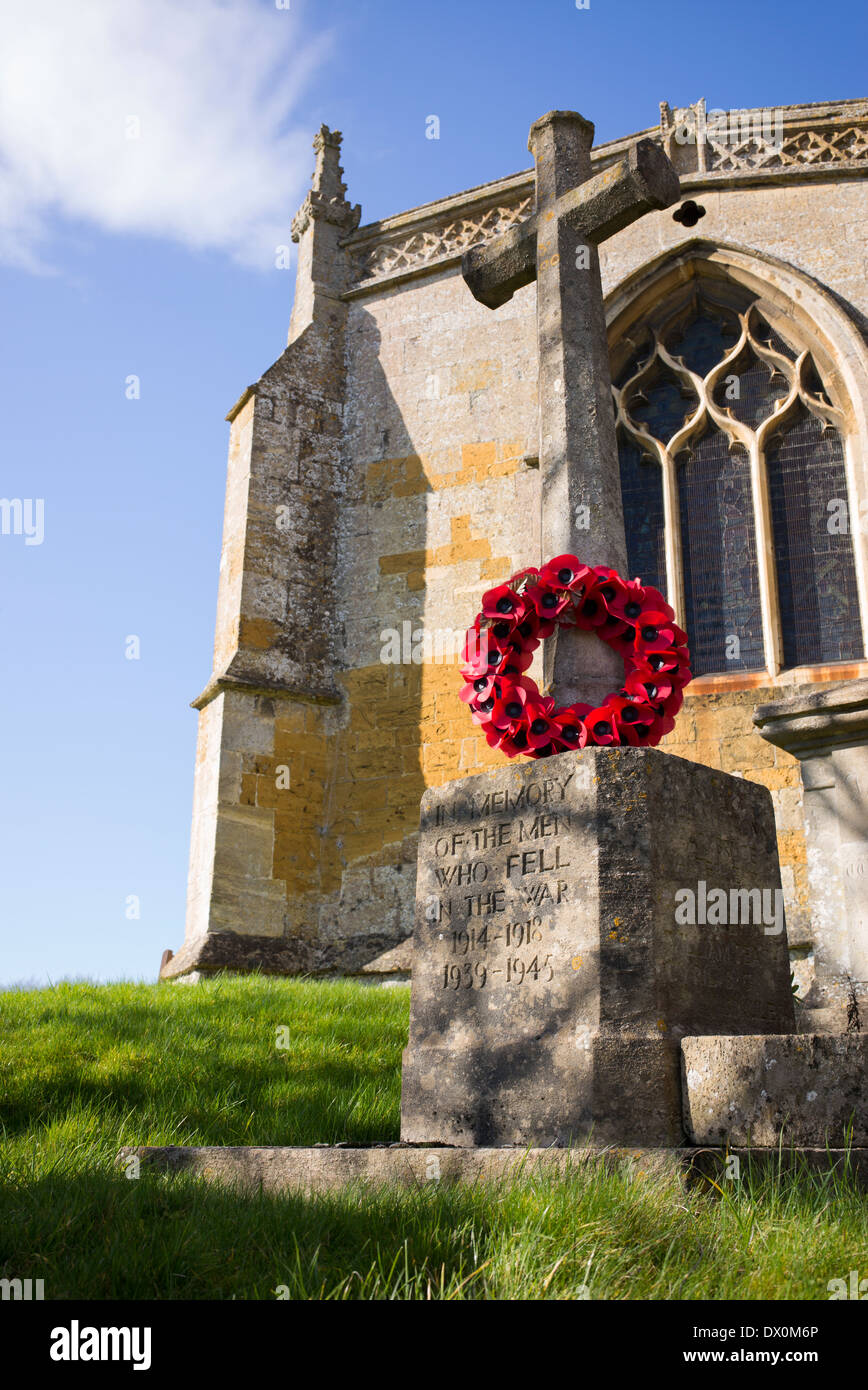 World War memorial and poppy wreath at St Lawrence Church, Bourton on the hill, Cotswolds, Gloucestershire, England Stock Photo