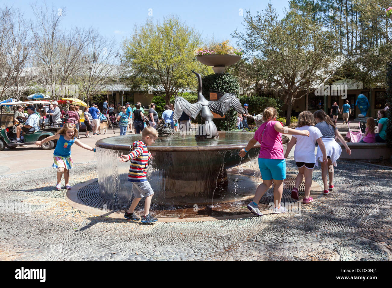 Children playing around a fountain in the Jacksonville, Florida zoo. Stock Photo