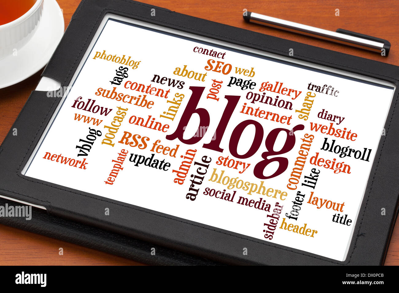 blog word cloud on a digital tablet with cup of tea and stylus pen Stock Photo