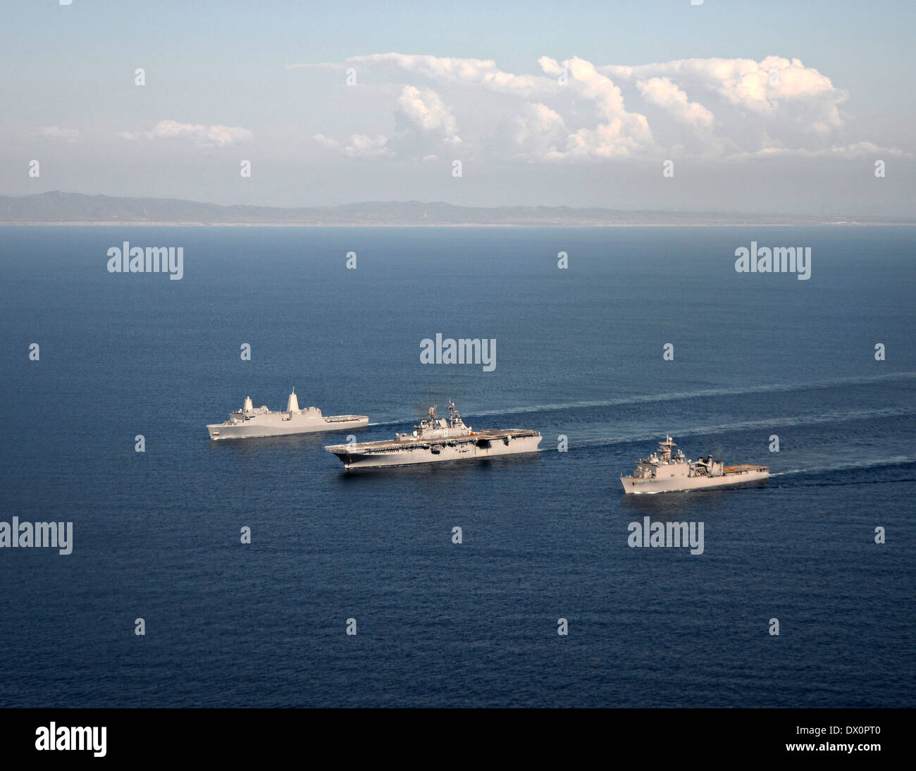 US Navy amphibious assault ship USS Makin Island alongside dock landing ship USS Comstock and amphibious transport dock ship USS San Diego during sea qualifications in preparation for its upcoming scheduled deployment March 13, 2014 in the Pacific Ocean. Stock Photo