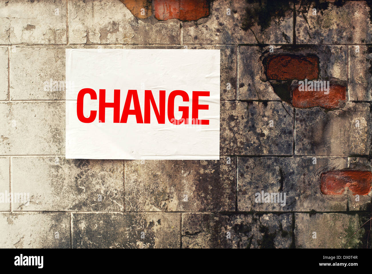 Change poster on grunge wall. Conceptual image. Stock Photo