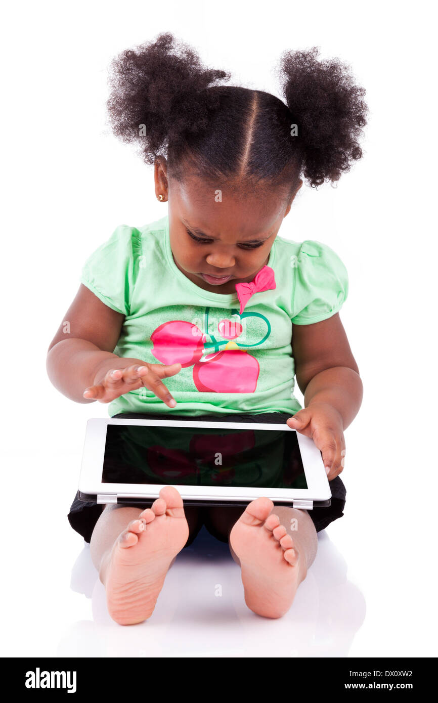 Little african american girl using a tablet pc, isolated on white ...