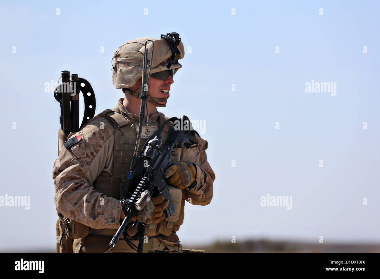 US Marine Corps Cpl. Nathon Swygart, a fire team leader with the 9th Marine Regiment, provides security during a patrol March 5, 2014 in Helmand province, Afghanistan. Stock Photo