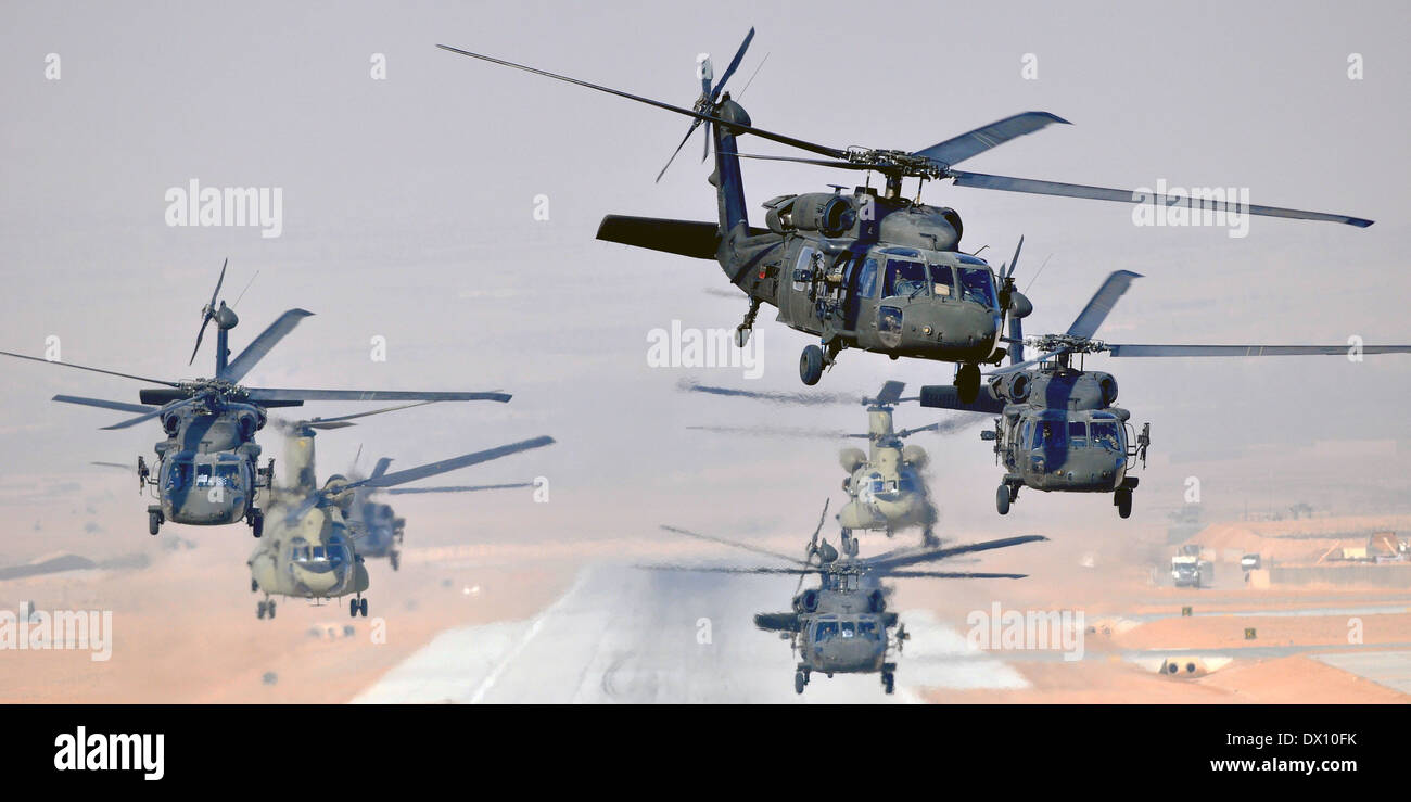 Six US Army UH-60L Black Hawks and two CH-47F Chinooks helicopters, assigned to Task Force Brawler simultaneously launch a daytime mission January 18, 2013 from Multinational Base Tarin Kowt, Afghanistan. Stock Photo