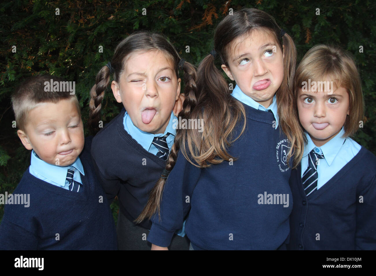 Four children pull funny faces in an alternative to the traditional school photograph, UK, England Stock Photo