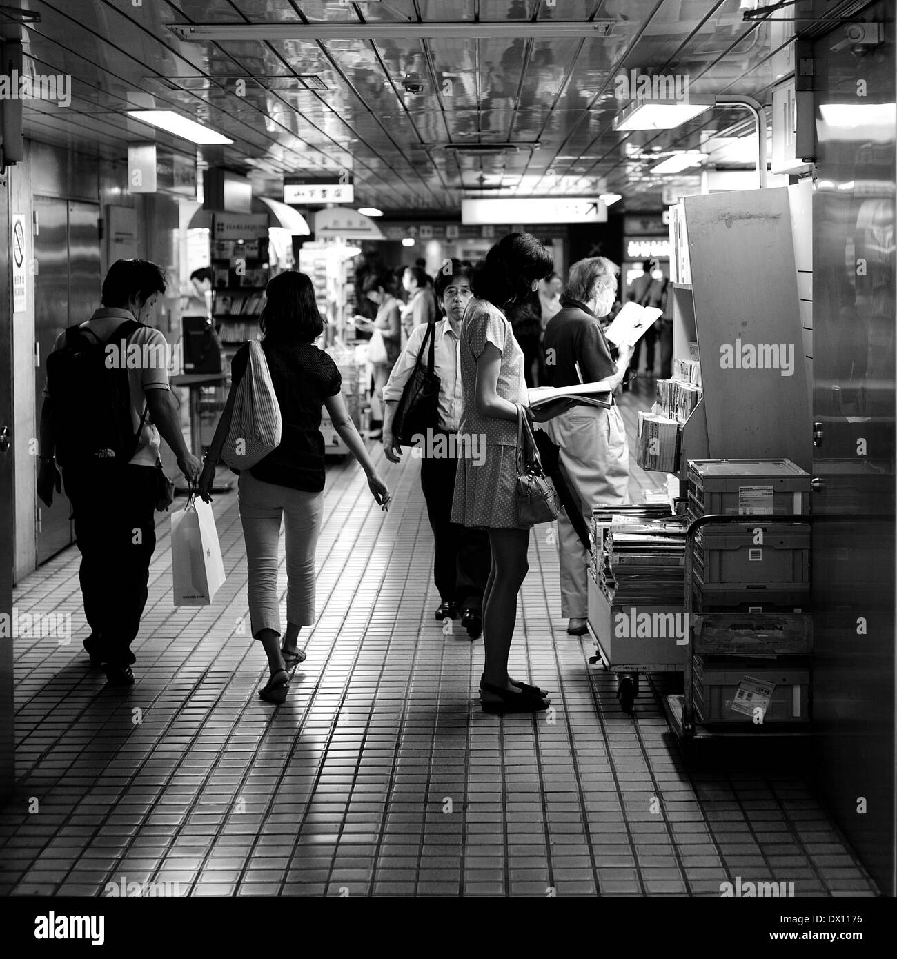 Woman Reading In Underground Shinjuku, Tokyo, Japan Stock Photo