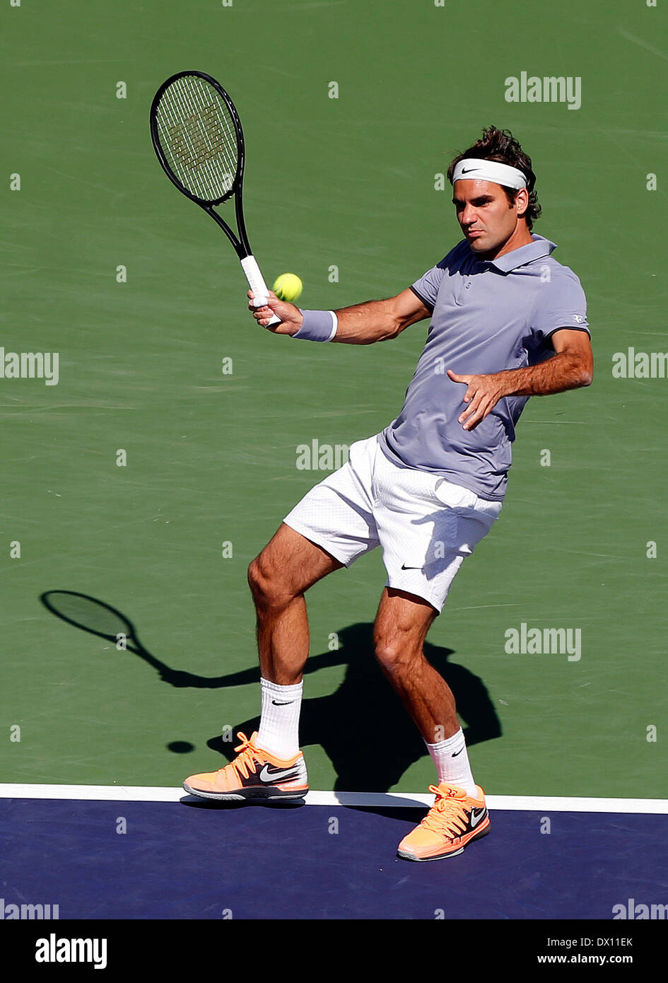 15 March, 2014: Roger Federer of Switzerland hits a return to Alexandr  Dolgopolov of the Ukraine during the BNP Paribas Open mens singles  semi-finals at Indian Wells Tennis Garden in Indian Wells