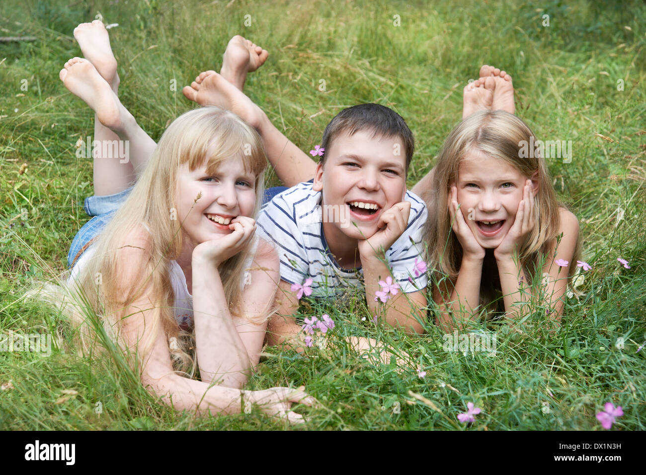 Boy lying on grass legs hi-res stock photography and images - Alamy