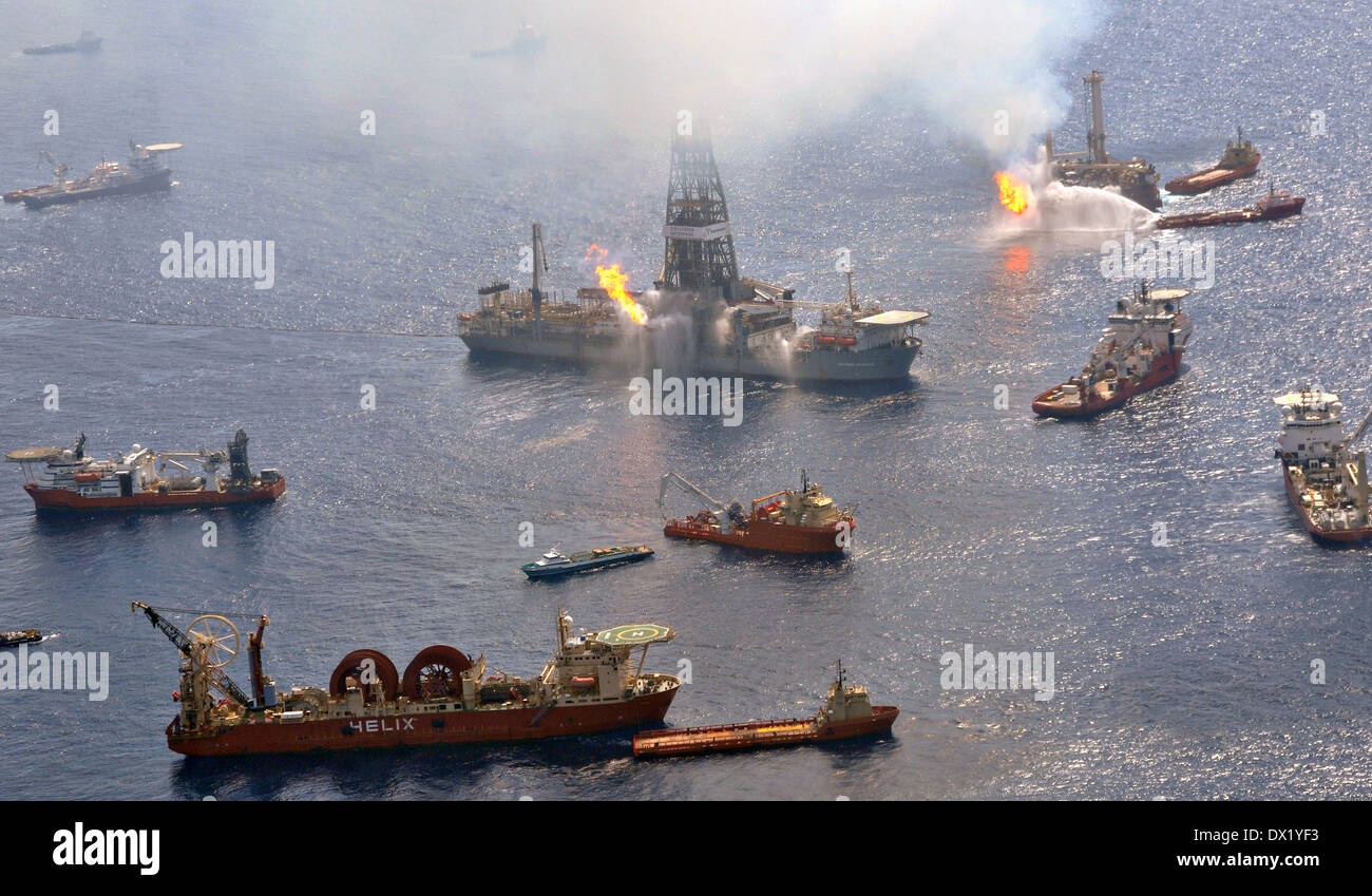 Oil skimming vessels operate around the the site of the Deepwater Horizon disaster as drill ship Discoverer Enterprise burns off gas from the wellhead June 26, 2010 in the Gulf of Mexico. Stock Photo