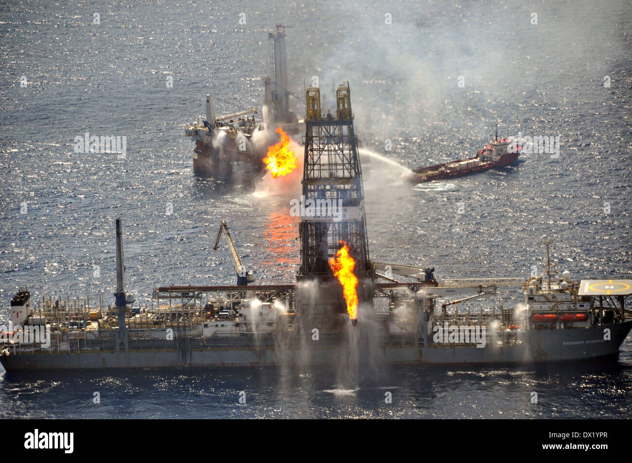 The drill ship Discoverer Enterprise and Q4000 burn off gas from the uncapped Deepwater Horizon wellhead as clean up continues in the largest oil disaster in history June 26, 2010 in the Gulf of Mexico. Stock Photo