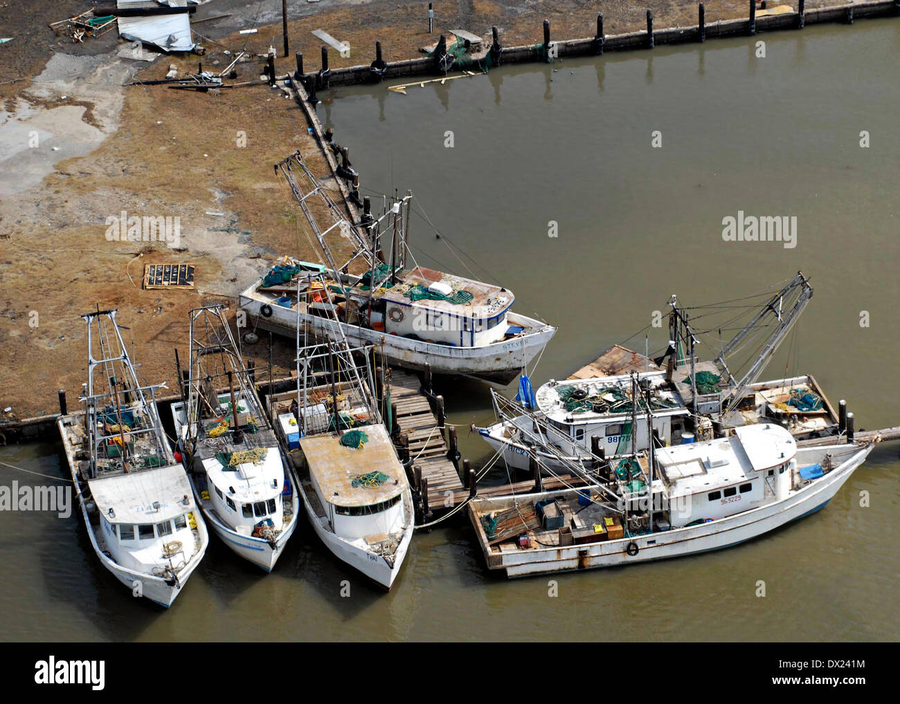Damaged fishing boats thrown on shore by Hurricane Ike at a boatyard on the Bolivar Peninsula September 13, 2008 in Galveston, Texas. Hurricane Ike struck the Texas Gulf Coast as a strong Category 2 storm causing widespread damage to the region. Stock Photo