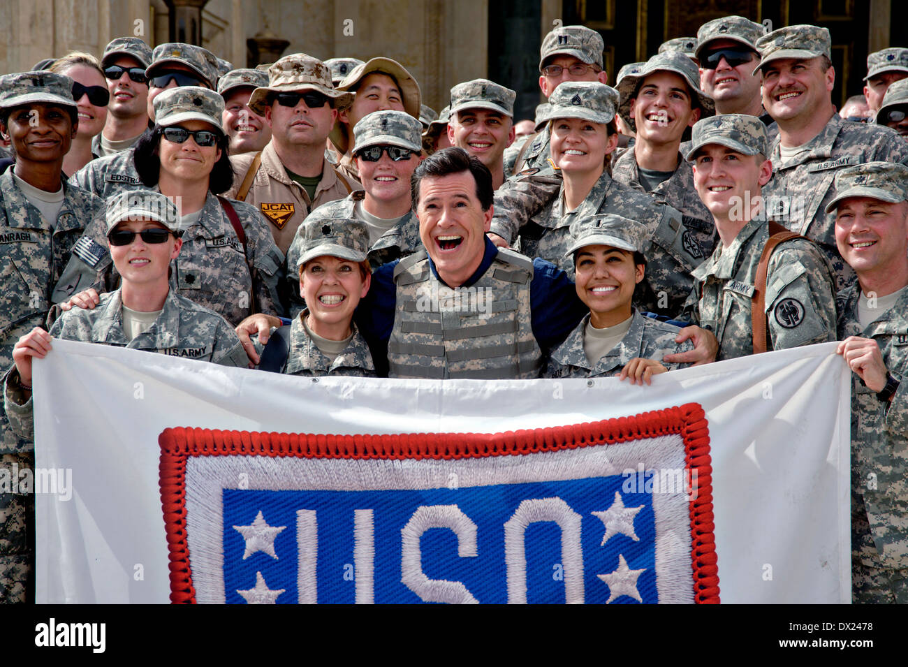 Comedian Stephen Colbert poses for a photo with service members during his USO tour at Camp Victory's Al Faw Palace June 5, 2009 in Baghdad, Iraq. Stock Photo