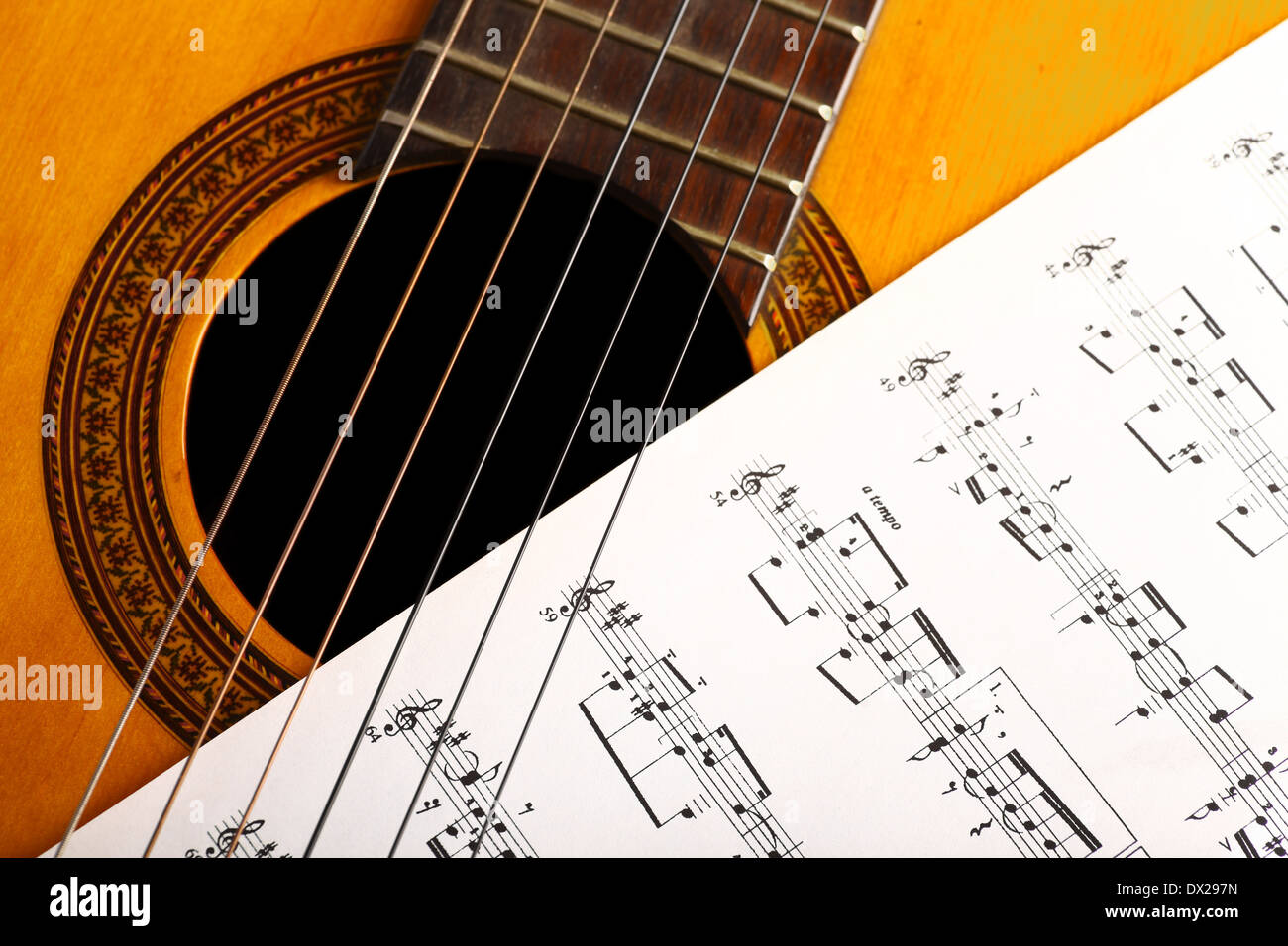 A classical guitar and a music sheet Stock Photo Alamy