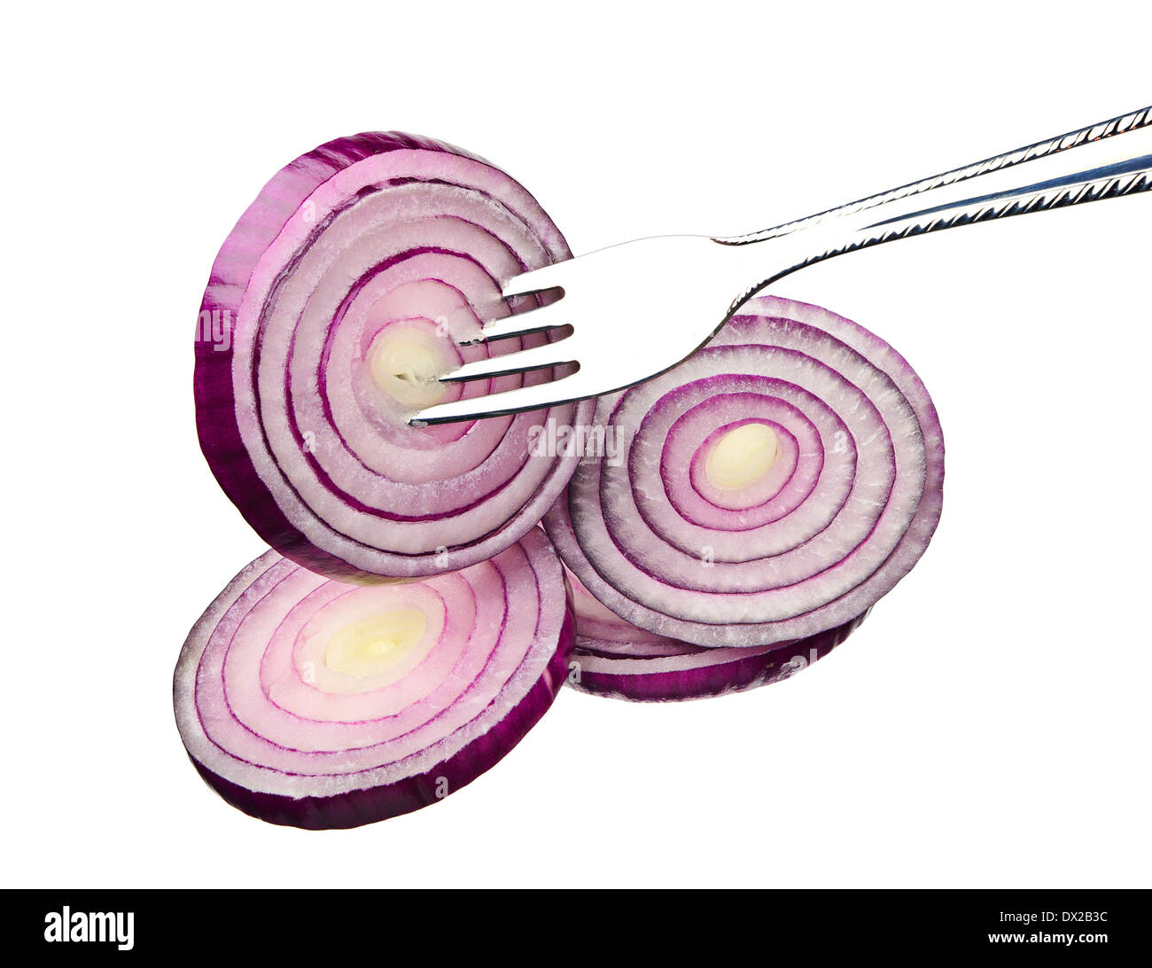 Red onion sliced on a fork isolated on a white background Stock Photo
