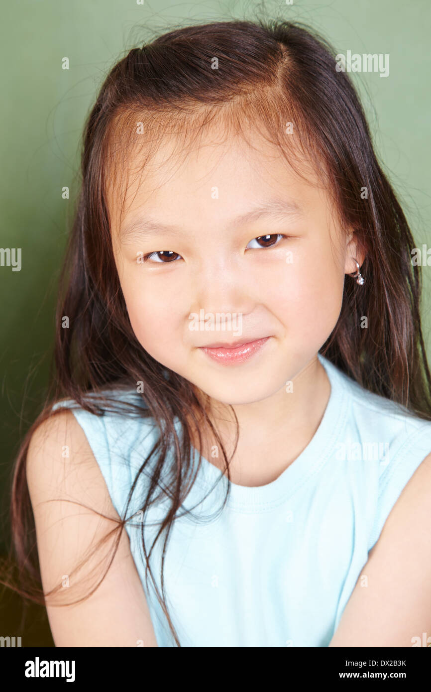 Portrait of a smiling chinese girl in front of a chalkboard Stock Photo