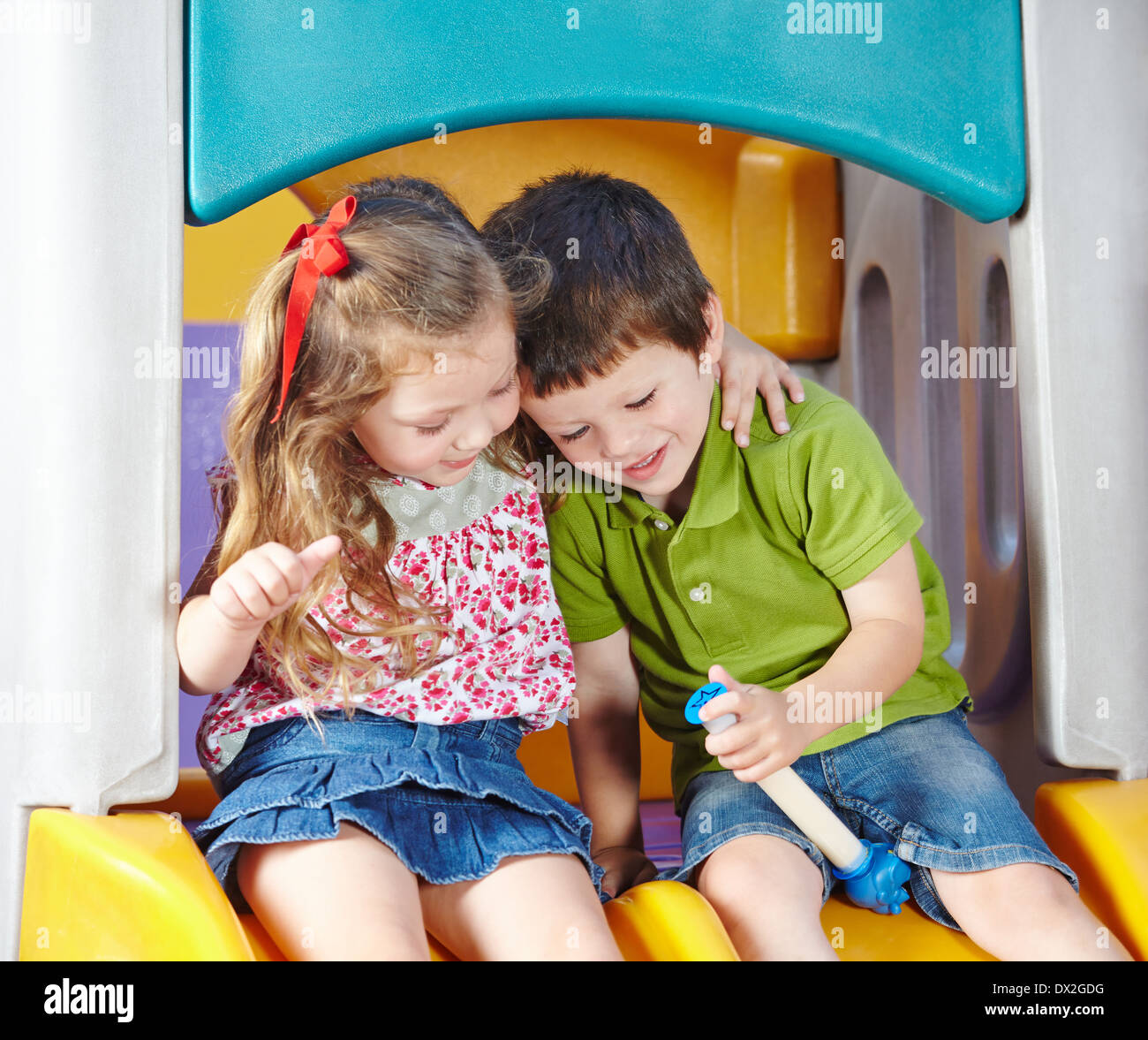 Boy and girl as children friends playing together in a kindergarten