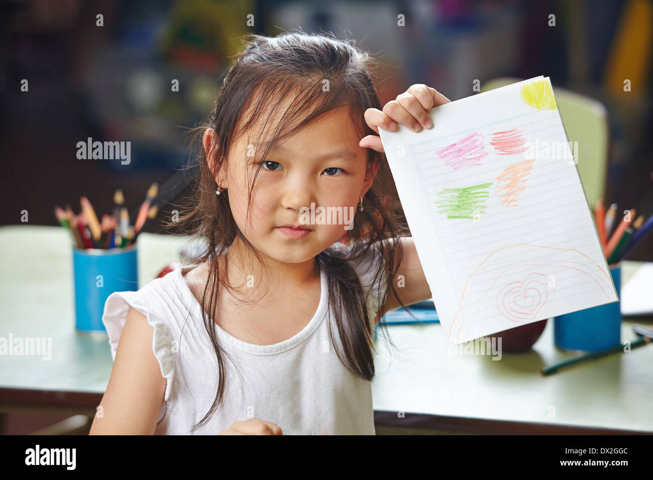 Asian girl showing her drawing in a kindergarten Stock Photo Alamy