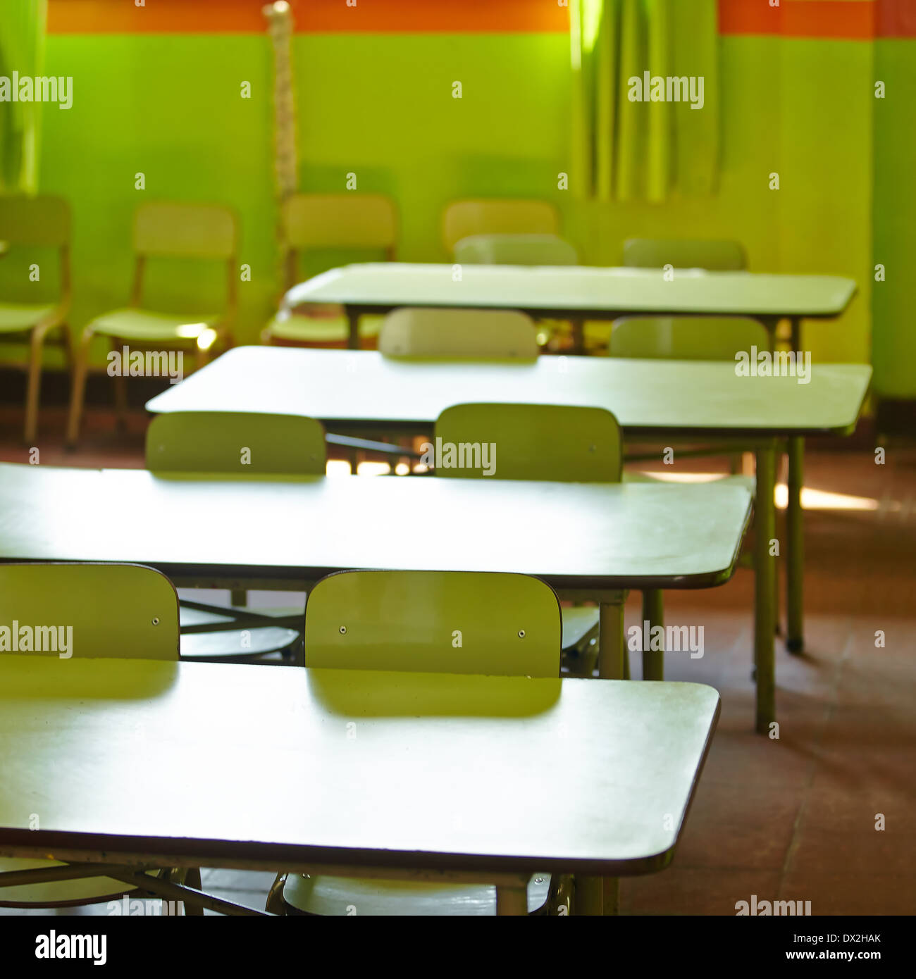 Empty classroom in a elementary school with tables and chairs Stock Photo