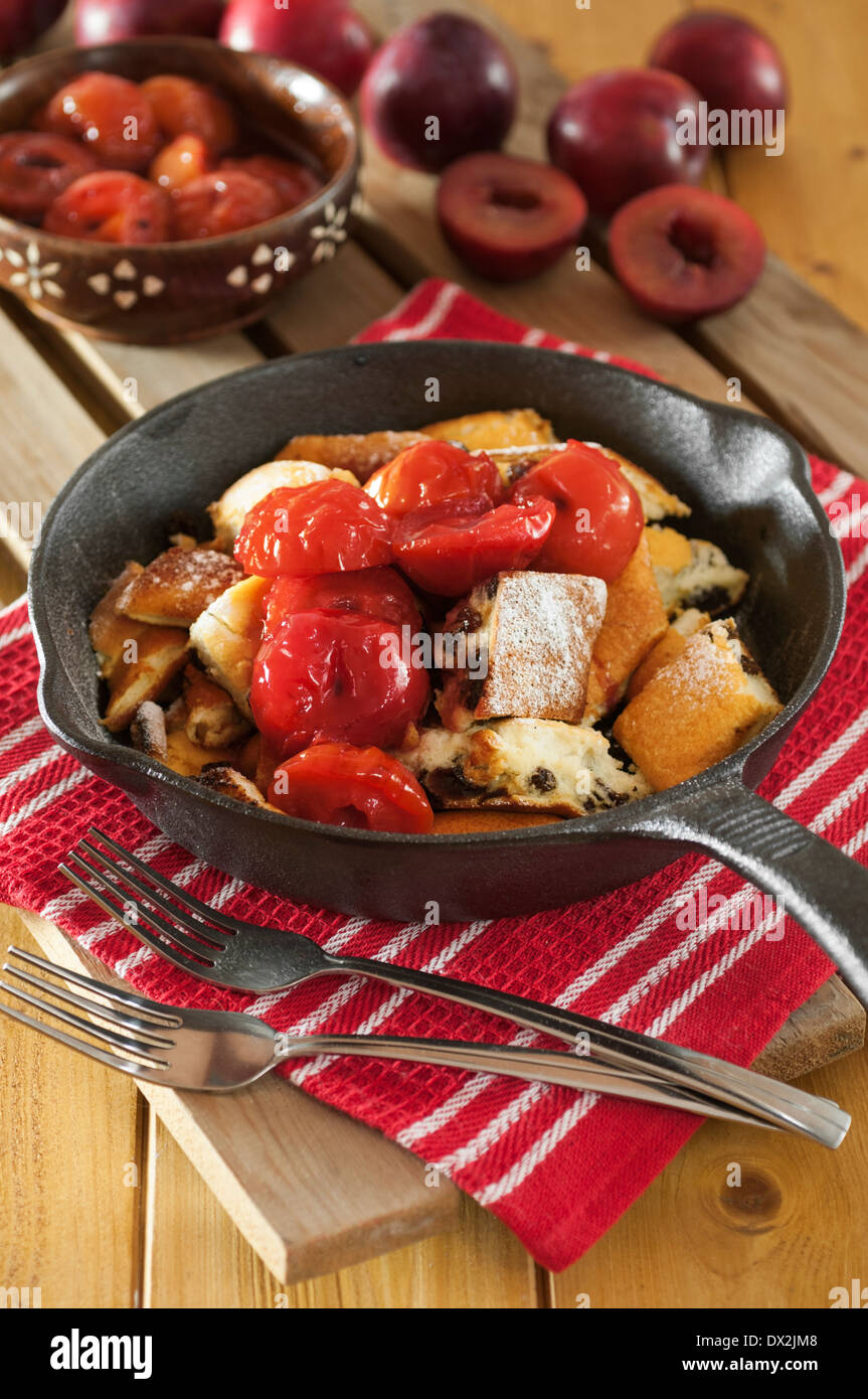 Kaiserschmarren. Shredded pancake dessert with plum compote Stock Photo