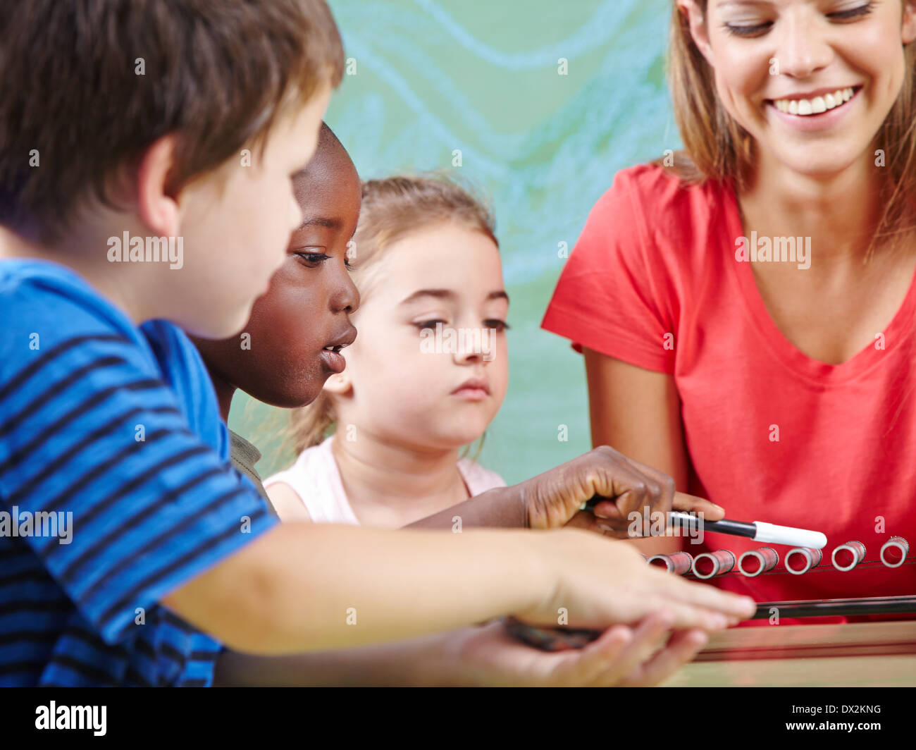 Children learning instruments in music school in musical education