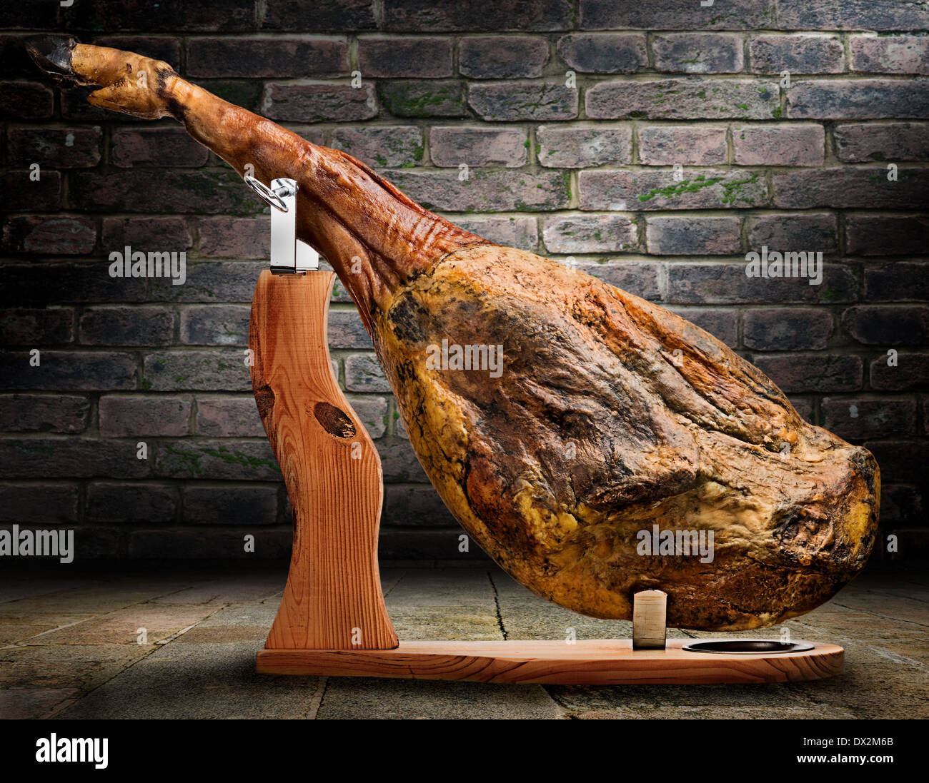 A front leg of Serrano ham mapped on a wooden stand on artistic background Stock Photo Alamy