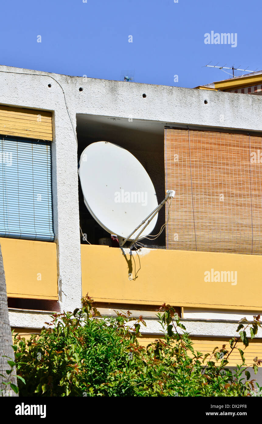 Satelite dish attached on an old apartment balcony building in Fuengirola, Spain. Stock Photo