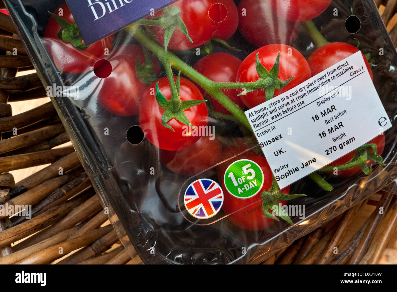 TOMATOES CARTON BRITISH English 'Sophie Jane'  vine tomatoes in supermarket packaging with Union Jack motif &  health sticker '1 of 5 a-day' in basket Stock Photo