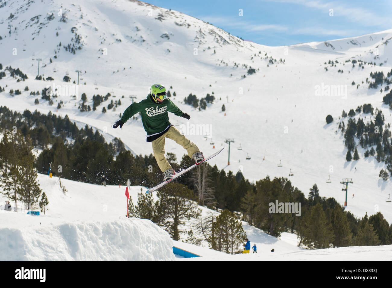 Freestyle Snowboarders jumping and pulling tricks in the winter sports resort of Soldeu, Andorra. Stock Photo